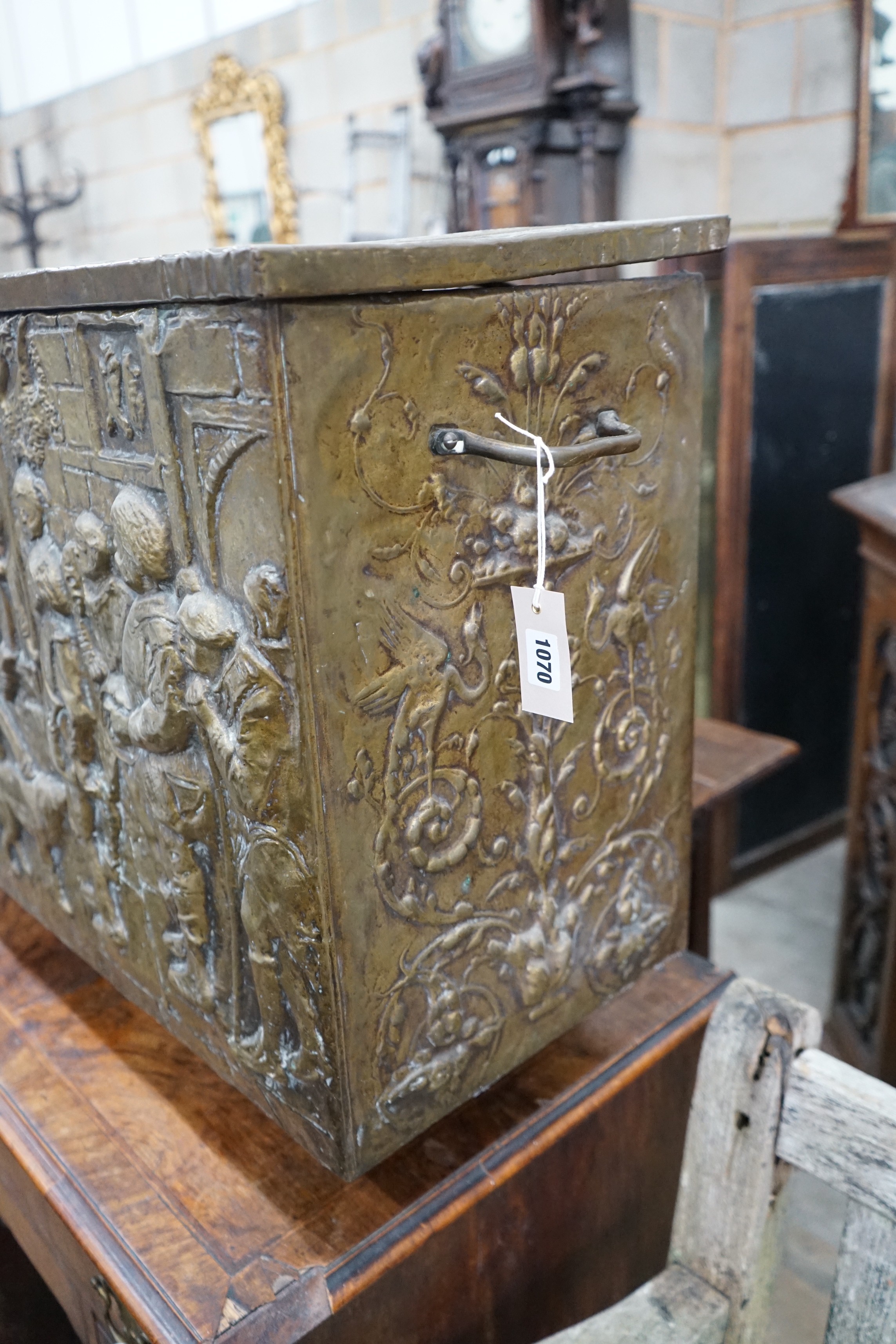 A Dutch style brass repousse log box, width 79cms, depth 35cms, height 57cms.